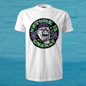 White T-shirt featuring a circular graphic of a grinning chimpanzee wearing a purple beanie, purple flowers, and green text on a teal background.