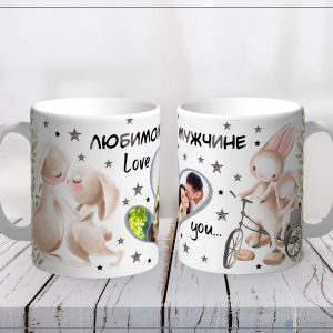 Two white mugs facing each other on a white wooden table, covered in romantic illustrations, stars, rabbits, and the words 'Love you' (pair of themed mugs).